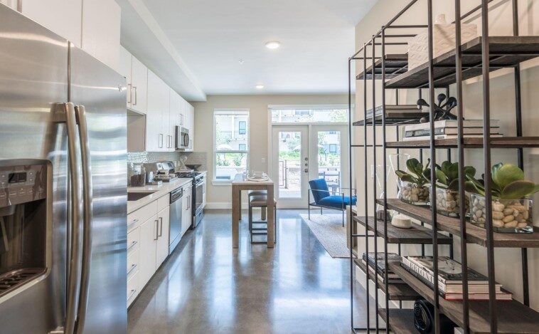 Sleek and modern kitchen interior at Eighteen25 Downtown Apartments with stainless steel appliances.