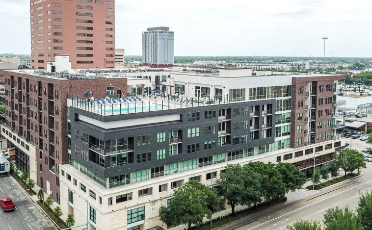 Aerial view of Eighteen25 Downtown Apartment Building in Houston showcasing the rooftop pool and modern architecture.